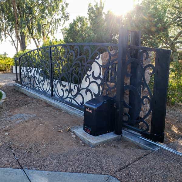 Custom wrought iron gate installation in Paradise Valley Arizona with Spanish Colonial scrollwork